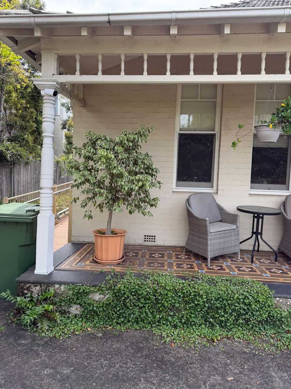 Cromehurst Cottage veranda in Lindfield, with outdoor seating and potted plants